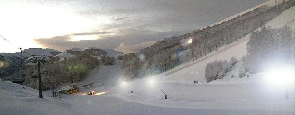 A winter scene from Scanno-Monte Rotondo ski resort located in Abruzzo, Italy, showcasing stunning winter scenery with a chalet and winter sports facilities.