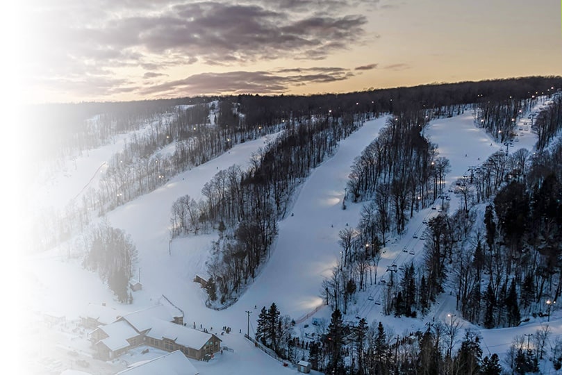 Ski resort in Vallée du Parc, Shawinigan featuring a beautiful winter scenery with snow-covered slopes and a ski lift servicing the resort. A picturesque winter sports scene in Quebec, Canada.