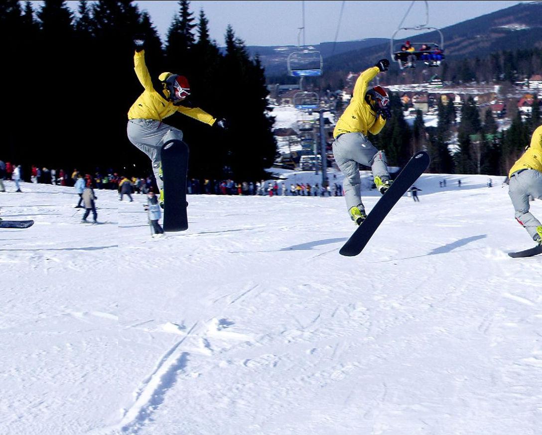 Čertova hora – Harrachov in Czech Republic - a group of snowboarders doing tricks in the snow.