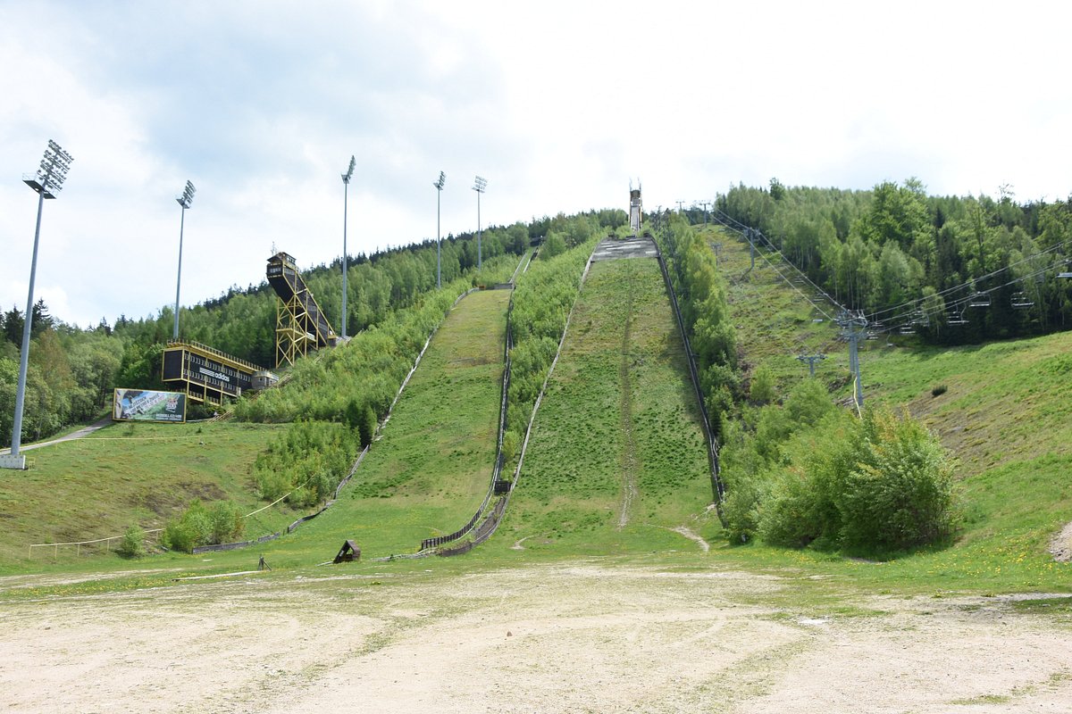 Čertova hora – Harrachov in Czech Republic - a ski slope with a ski lift going up it.