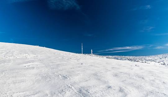 Winter scene at Martinské Hole ski resort in Slovakia, featuring a ski lift and a skier enjoying the snow-covered slopes at this popular winter sports centre.