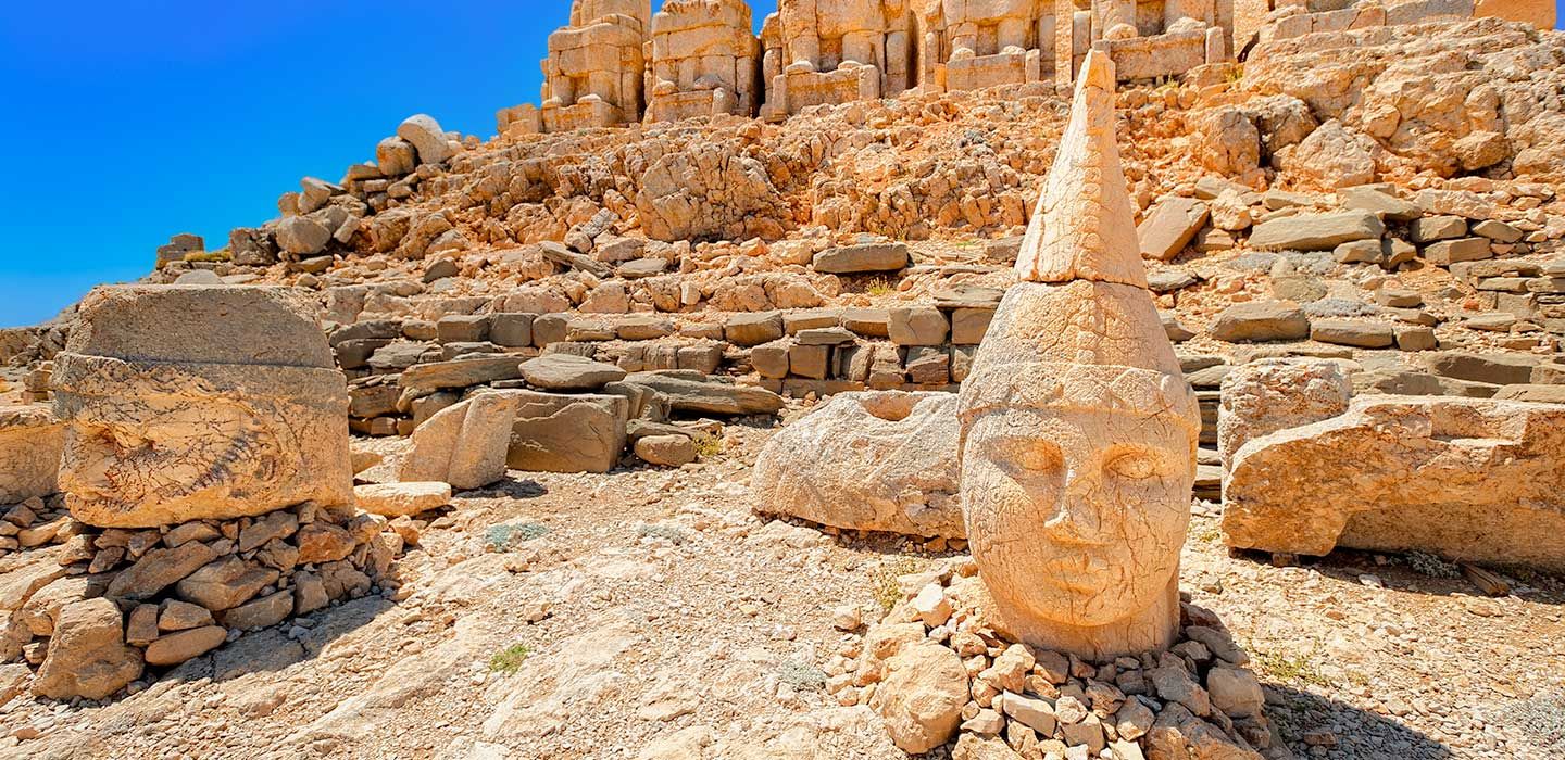 Mount Nemrut in Turkey - a rock formation on the side of a mountain.