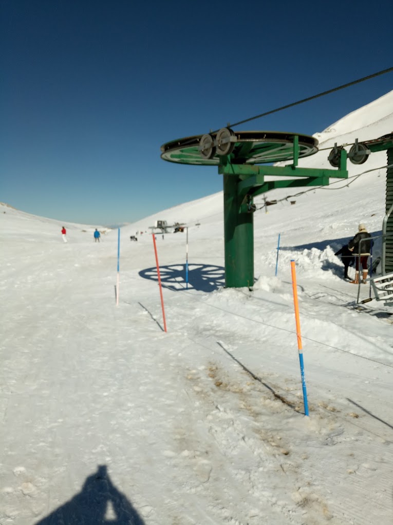 Velouchi Snow Centre S.A. in Greece - a ski lift on the side of a snowy mountain.