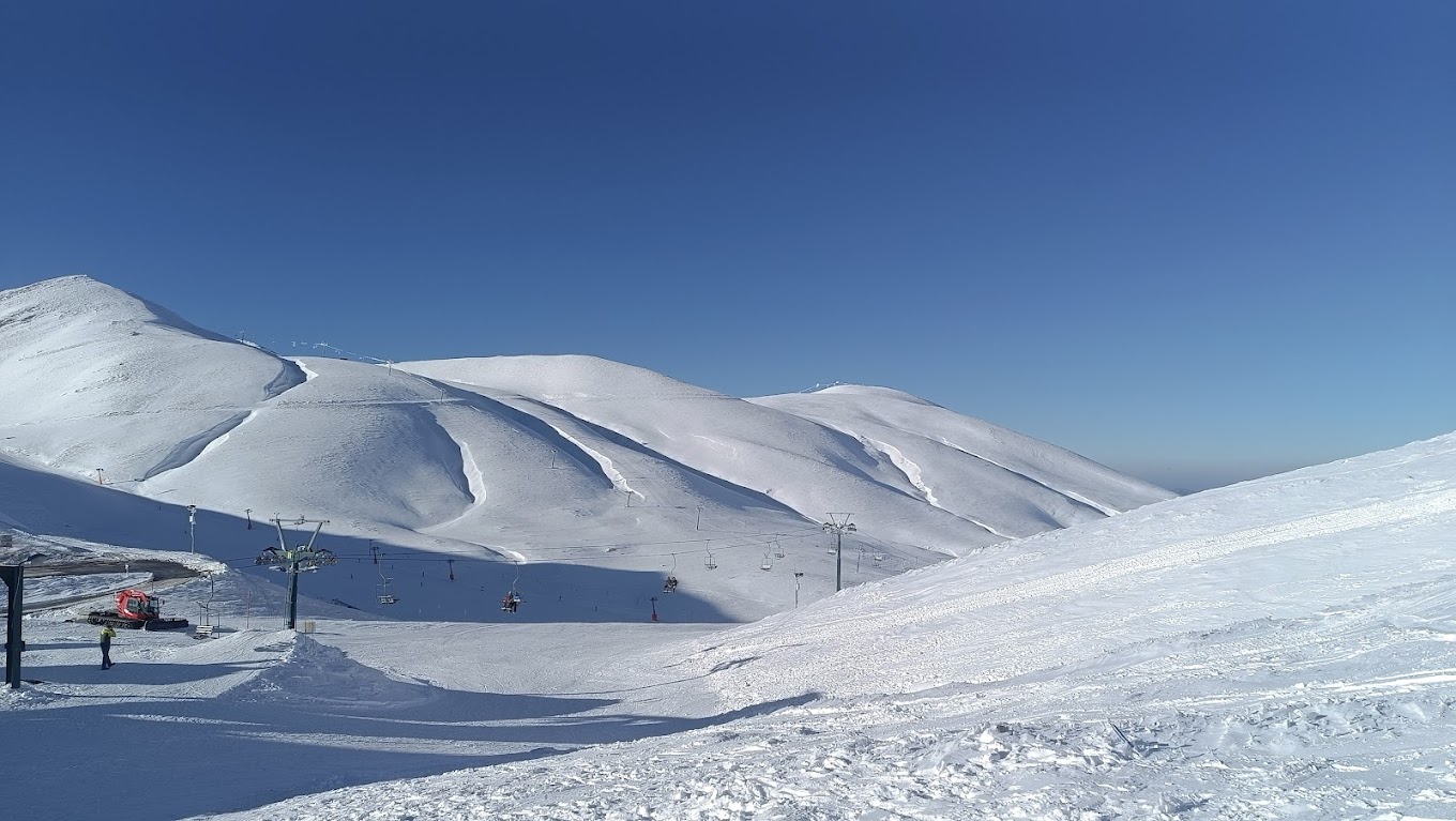 Velouchi Snow Centre S.A. in Greece - a ski lift going up a snowy mountain.
