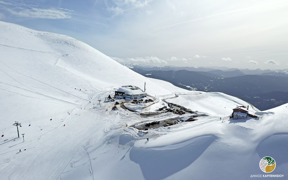 Velouchi Snow Centre S.A. in Greece - a group of people skiing down a snowy mountain.
