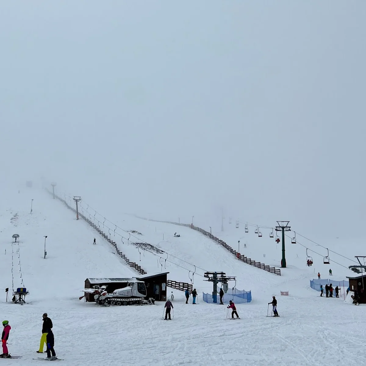 Velouchi Snow Centre S.A. in Greece - a group of people skiing down a snowy hill.