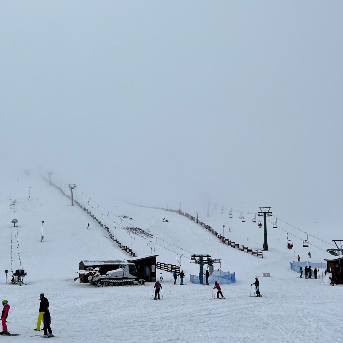 Velouchi Snow Centre S.A. in Greece - a group of people skiing down a snowy hill.