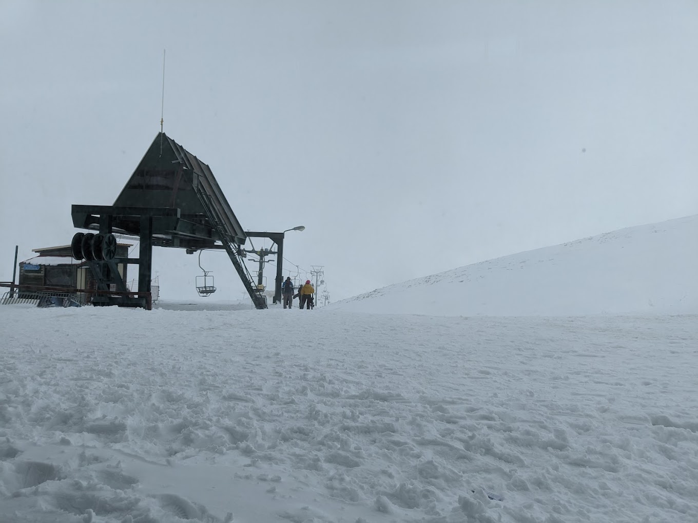 Velouchi Snow Centre S.A. in Greece - a truck is parked on the side of a snowy hill.