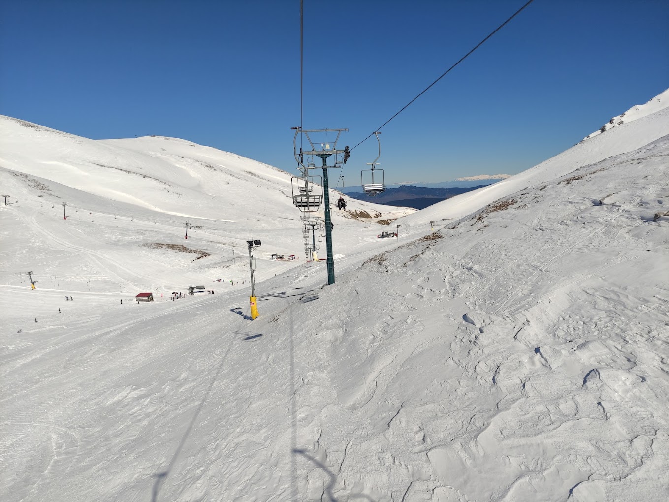Velouchi Snow Centre S.A. in Greece - a ski lift going up a snowy slope.