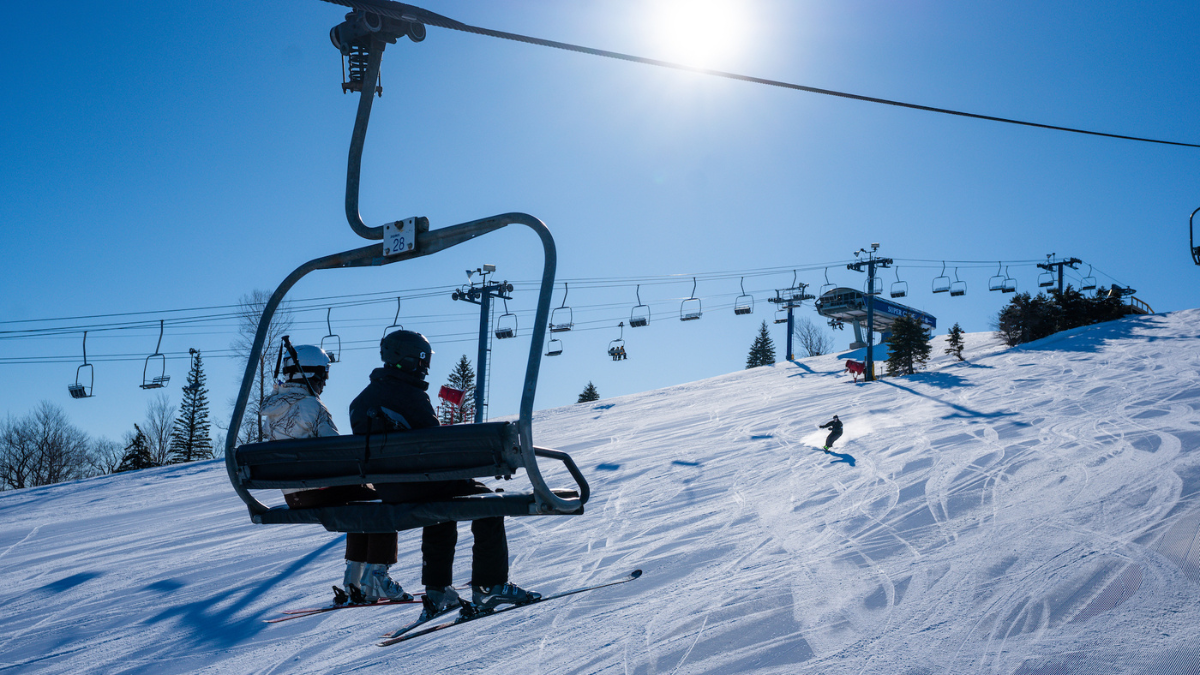 Alpine Valley Resort in USA - a person riding a ski lift on a snowy slope.