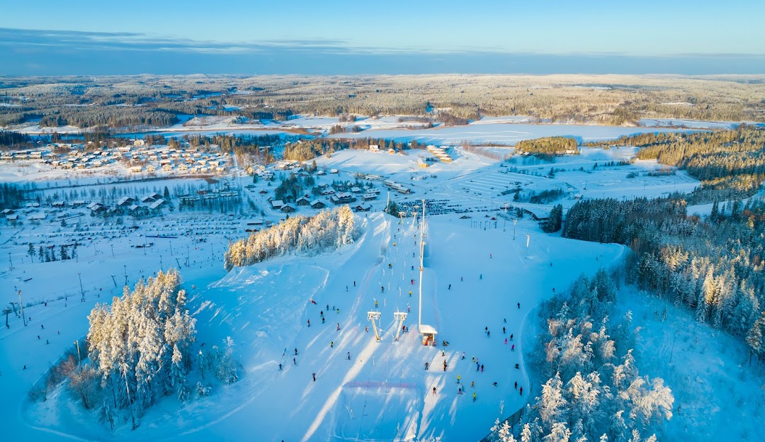 Winter sports scene at Himos in Jämsä, Finland, featuring a well-equipped winter sports centre and a ski resort set amidst the stunning winter scenery.