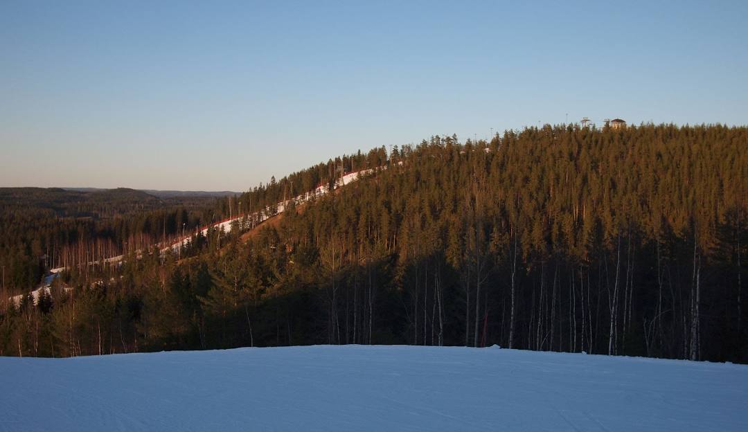 A lively winter sports scene at Himos ski resort in Jämsä West Finland featuring a ski lift amidst beautiful winter scenery.