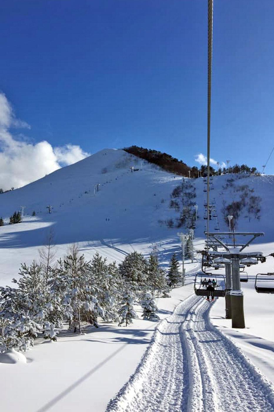 Moya Hills in Japan - a ski lift going up a snowy hill.
