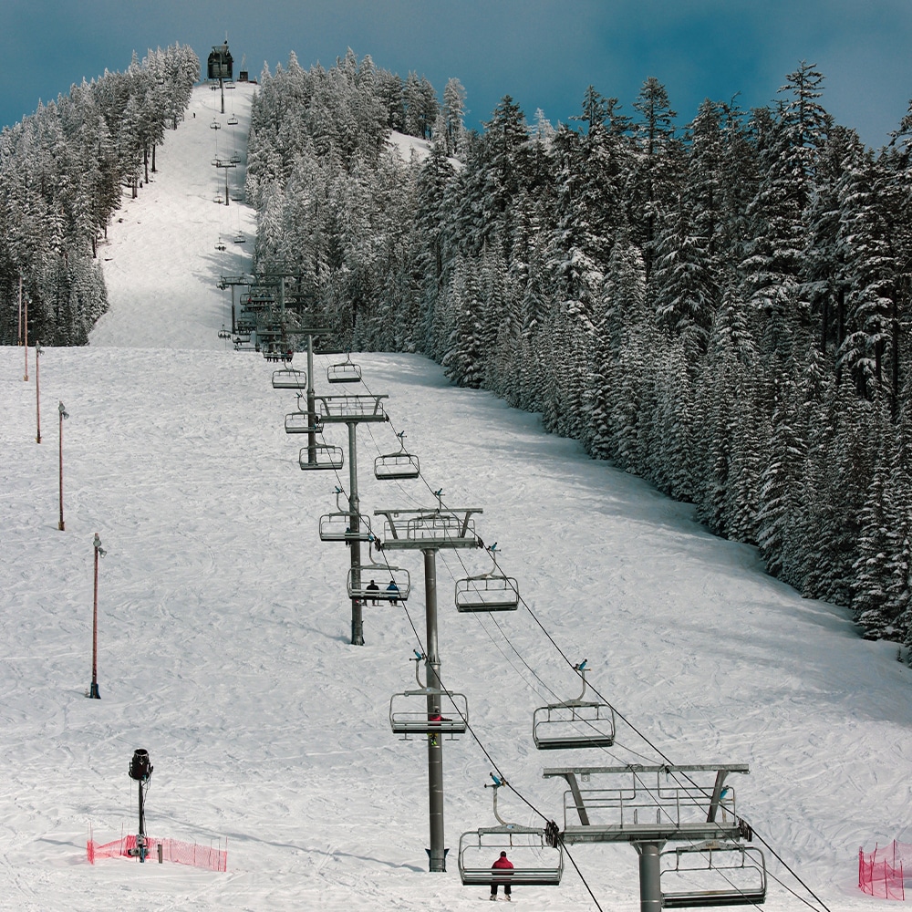 Las Vegas Ski and Snowboard Resort – Lee Canyon in USA - a ski lift going up a snowy hill.