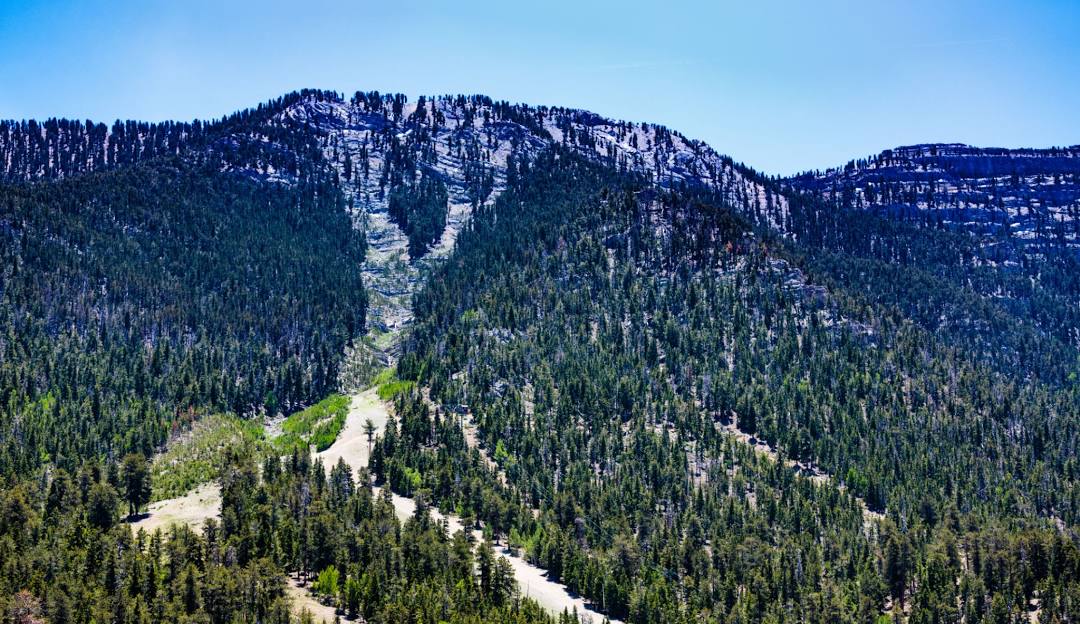 View of Las Vegas Ski and Snowboard Resort in Nevada, featuring a picturesque mountain landscape, the distant outline of the resort, and glimpses of a chalet and a ski lift.