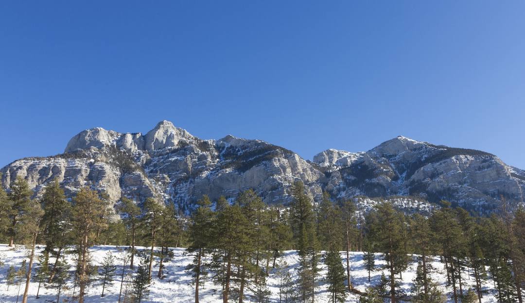 View of snow-covered Lee Canyon at Las Vegas Ski and Snowboard Resort, with a winter sports scene adding life to the stunning winter scenery.