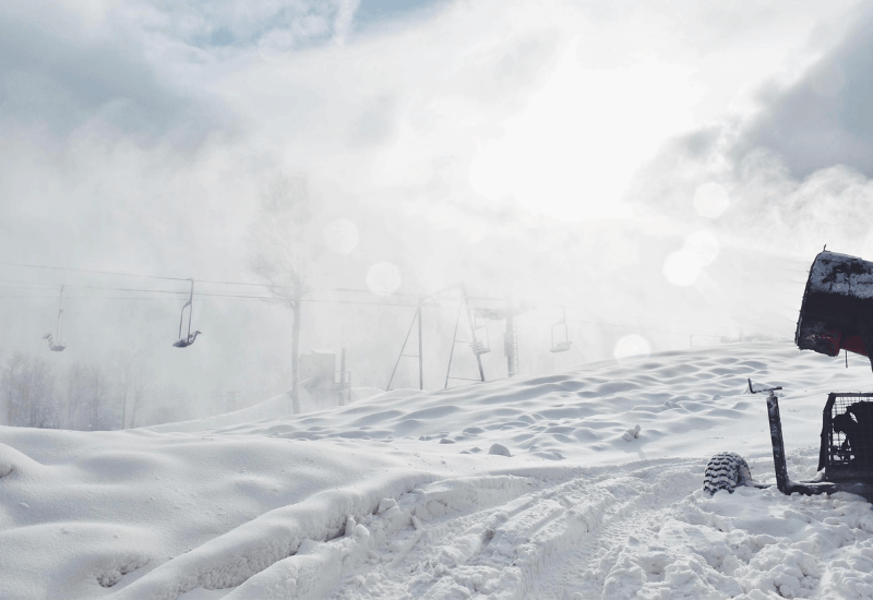 Stunning winter view of the Ski Brule in Michigan, capturing a winter sports scene with a skier cruising down the snowy slopes amidst beautiful surroundings of a popular ski resort.