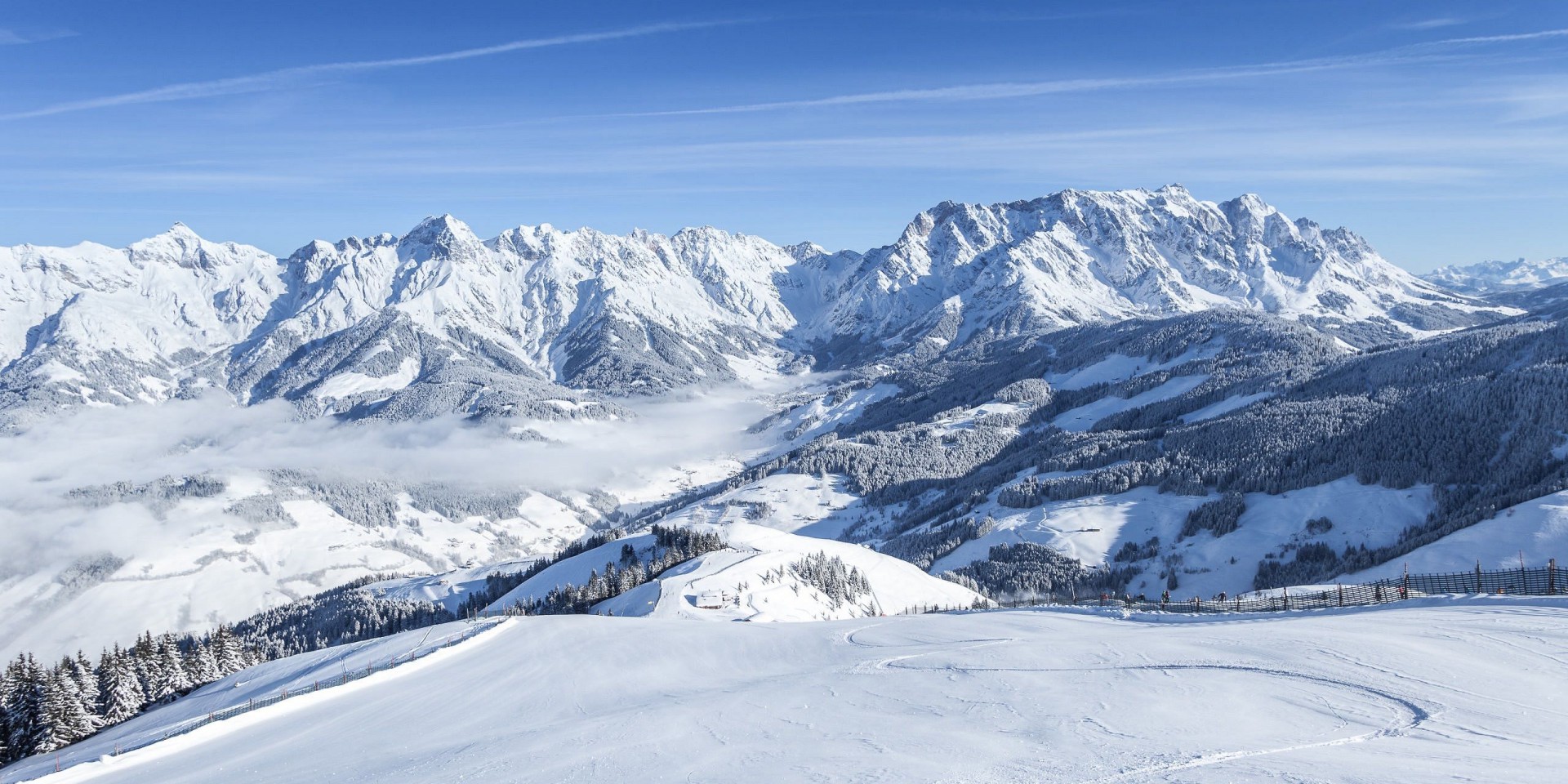 Winter scene at Hochkönigin ski resort in Austria, showcasing snow-covered slopes for winter sports, and a charming chalet nestled amidst the stunning alpine scenery.