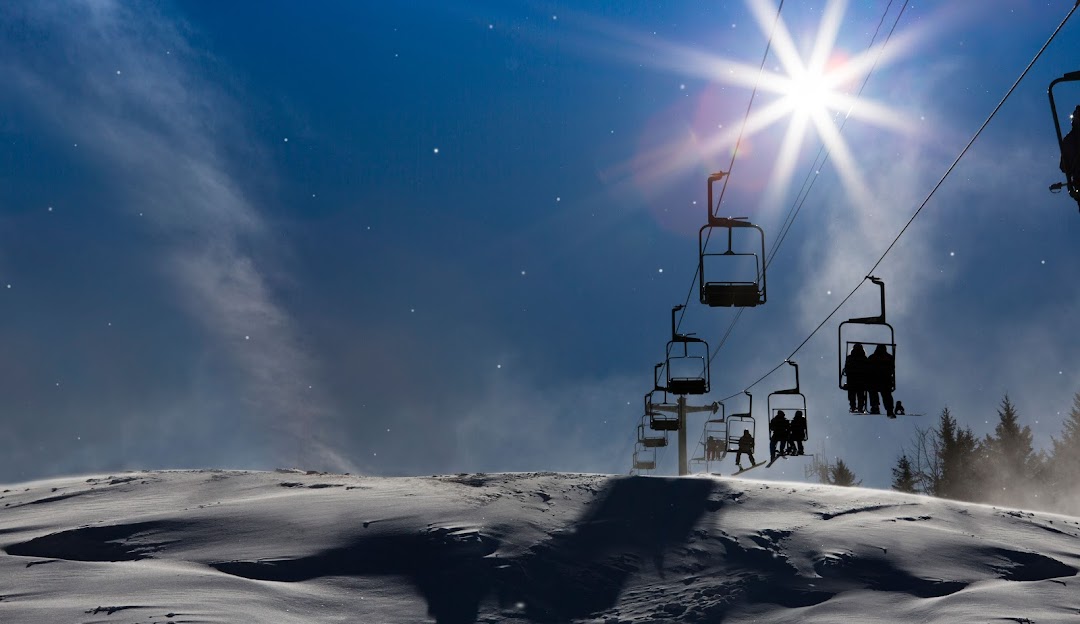 McCauley Mountain Ski Center in USA - a ski lift going up a snowy hill.