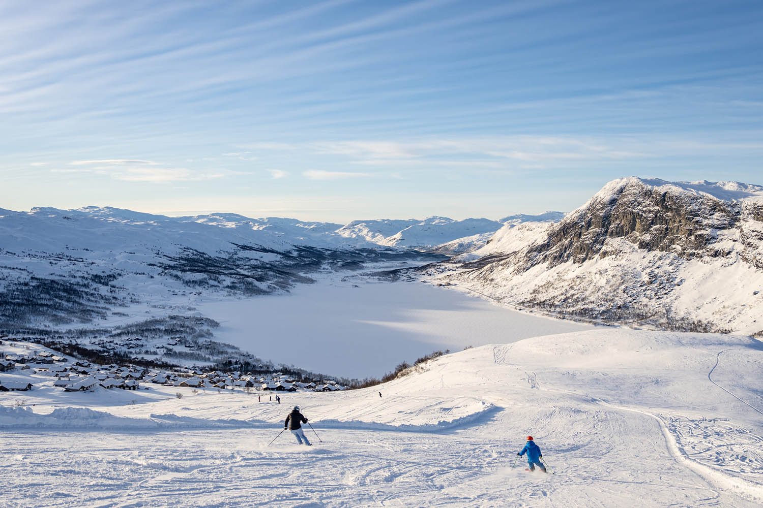 Tyin-Filefjell in Norway - a person skiing down a snowy slope in the mountains.