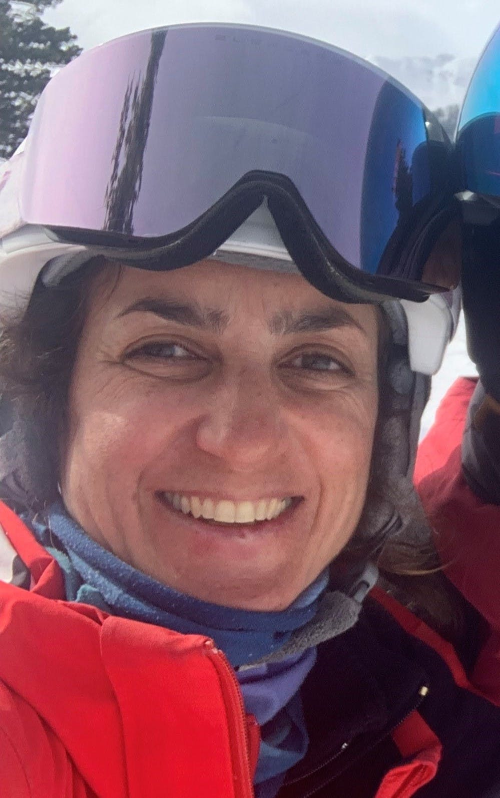 A skier enjoying the slopes at Ski-Waldheimat Hauereck in Austria's Styria region, with a ski lift and chalet in the background, embraced by a picturesque winter scene.