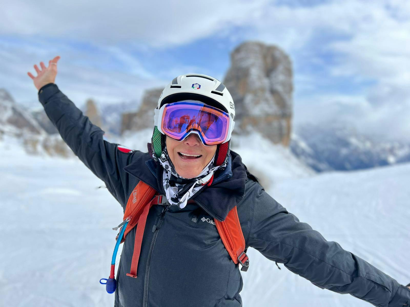 A skier gliding down a snowy slope at the picturesque Ski-Waldheimat Hauereck in Austria, with a charming challet nearby. The scenic mountain backdrop offers a perfect winter sports scene.