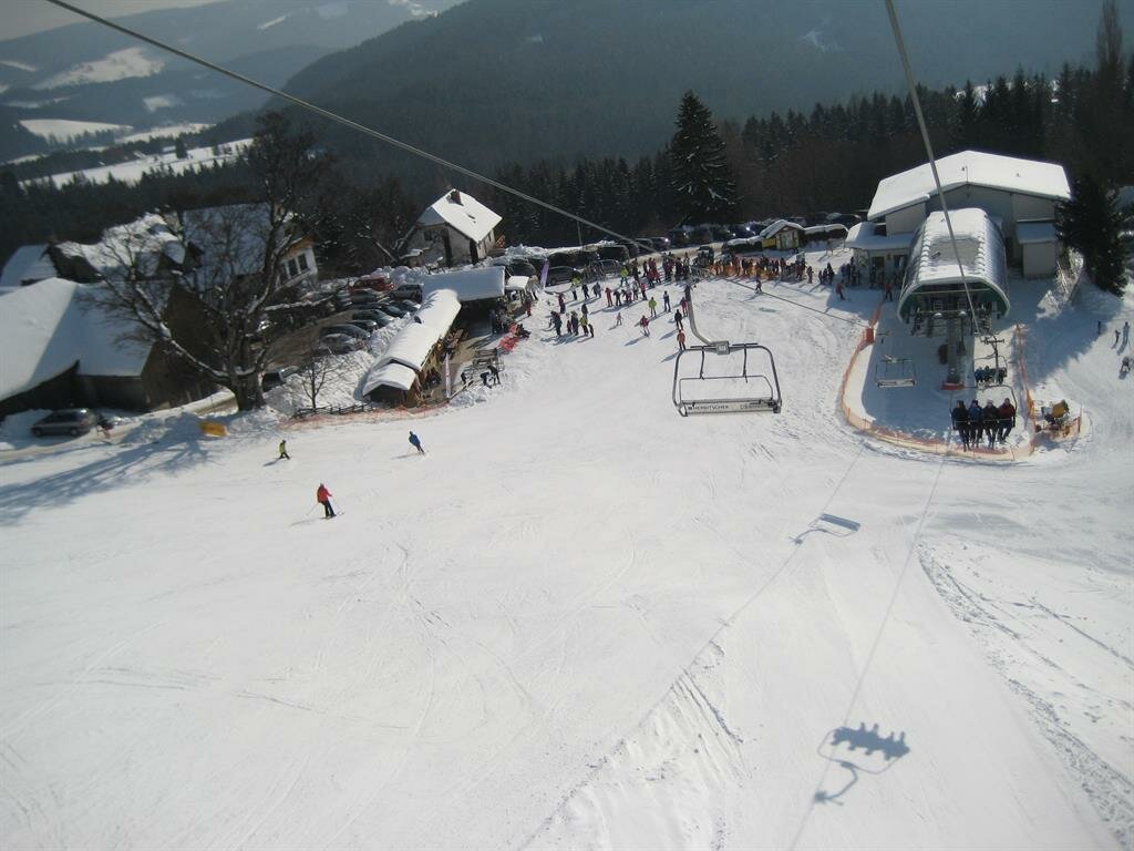 Ski-Waldheimat Hauereck in Austria - a group of people skiing down a hill.