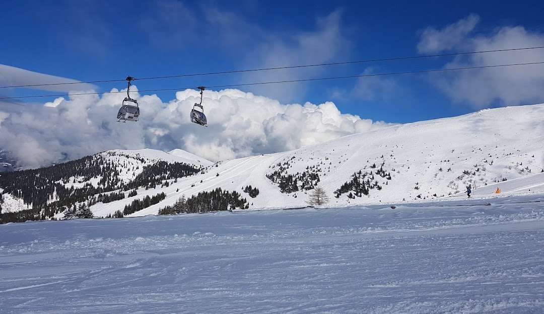 Enjoy a winter day at the Koralpe ski resort in Lower Carinthia Austria. Experience the charm of the chalet ski down the snow-covered slopes or take a ride on the ski lift. Perfect for ski enthusiasts.