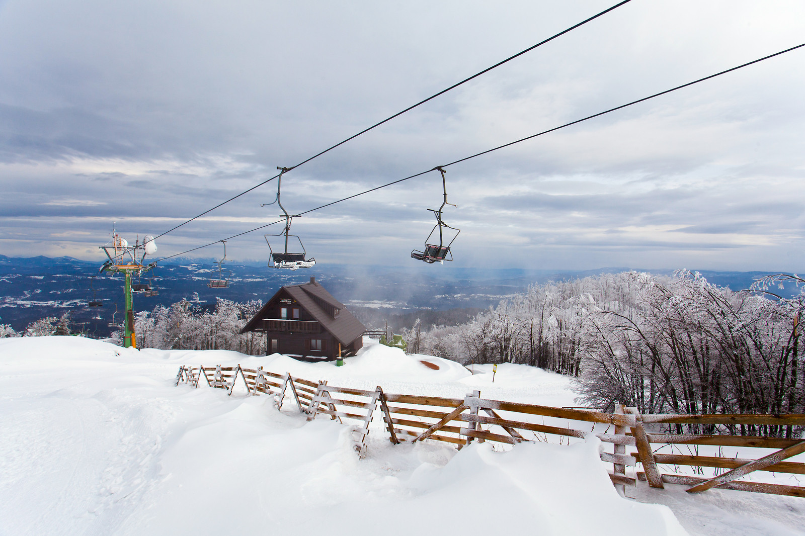 Javornik in Slovenia - a ski lift going up a snowy hill.