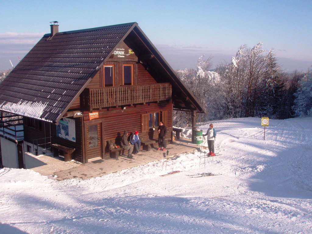 Javornik in Slovenia - a house in the snow with people outside.