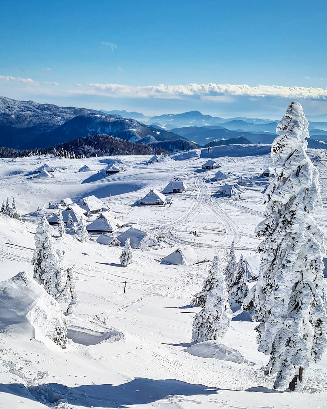 Velika Planina in Slovenia - a view of a ski area with snow covered trees.