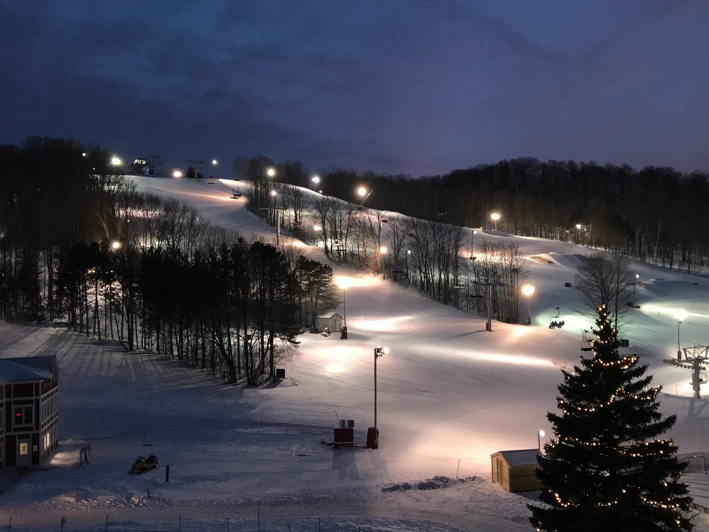 Winter view of Horseshoe Resort in Barrie, Ontario, featuring ski trails, expansive snowy landscape, and distant figures engaging in winter sports.
