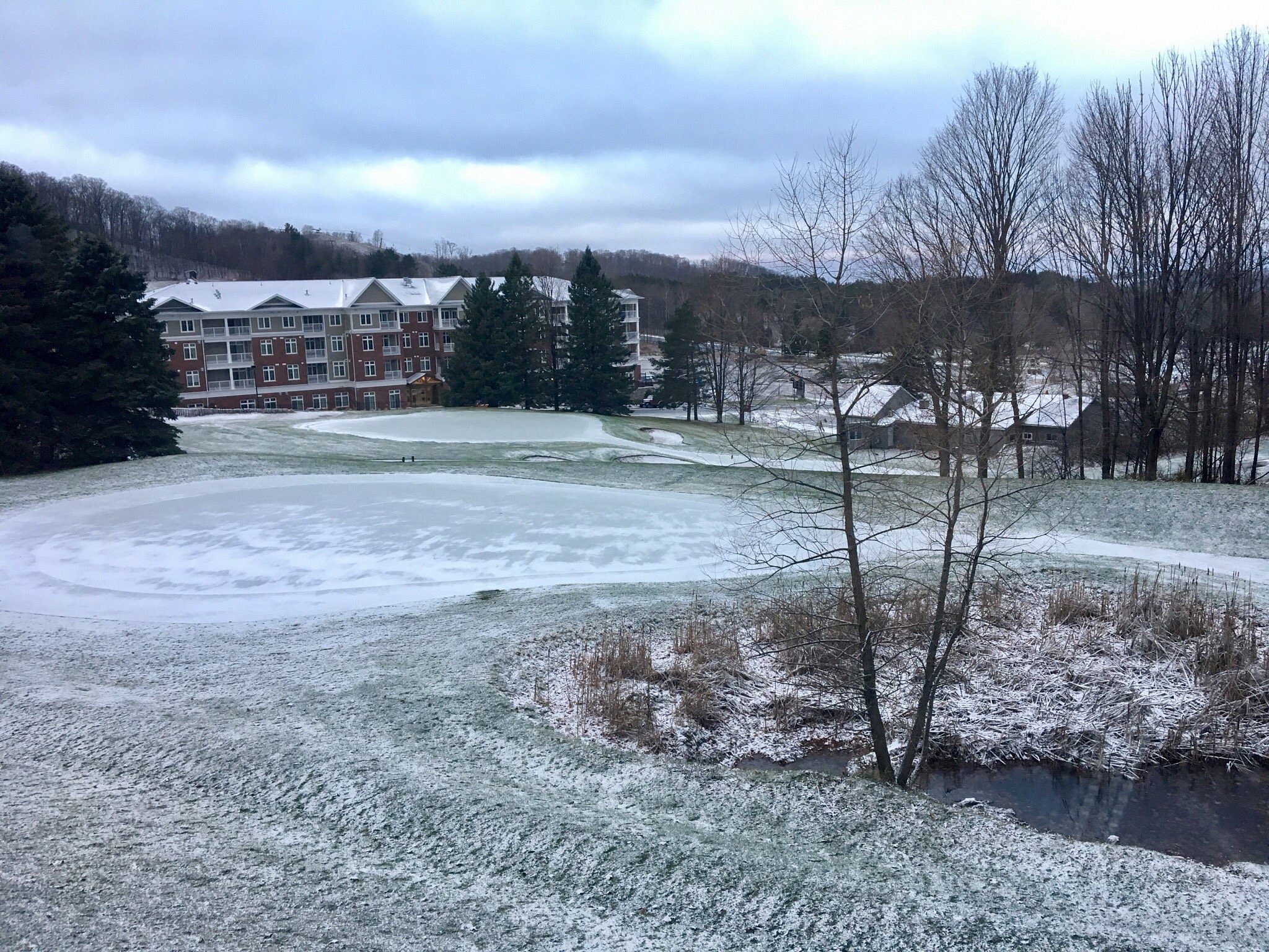 Winter sports scene at Horseshoe Resort Barrie Ontario showing bustling activity at the winter sports centre amidst stunning winter scenery and a distant lake.