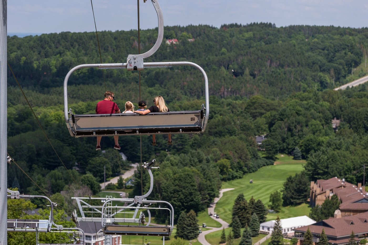 View of Horseshoe Resort in Barrie, Ontario displaying a prominently featured ski lift against the backdrop of a chalet and encompassing ski resort amidst a winter setting.