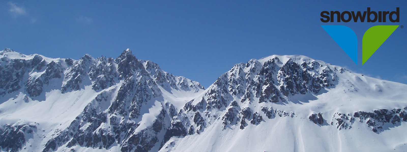 Snowbird in USA - a group of snow covered mountains under a blue sky.