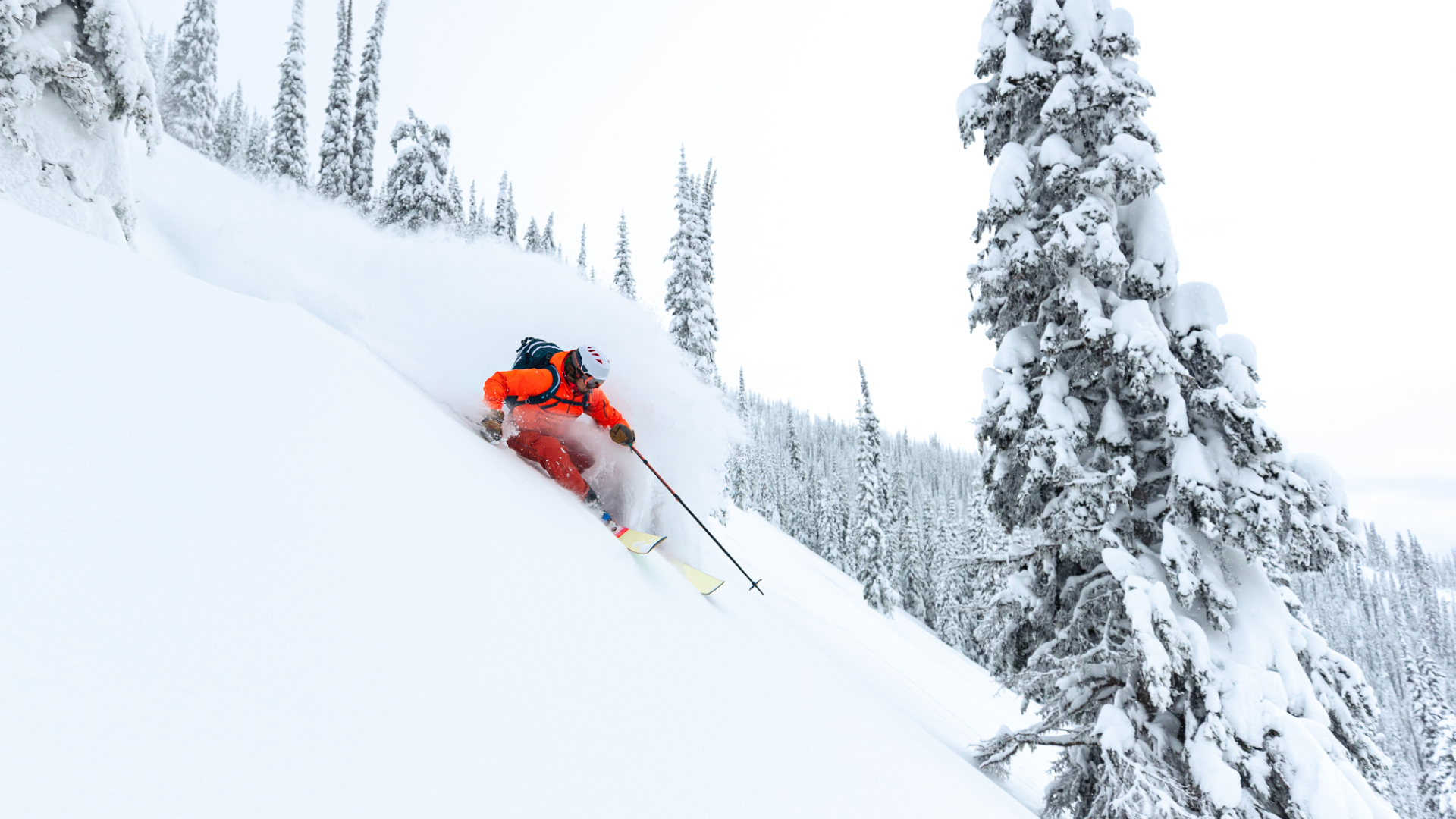 A skier tackles the snowy slopes of Borgafjäll in Northern Sweden surrounded by a beautiful winter sports scene at a ski resort.