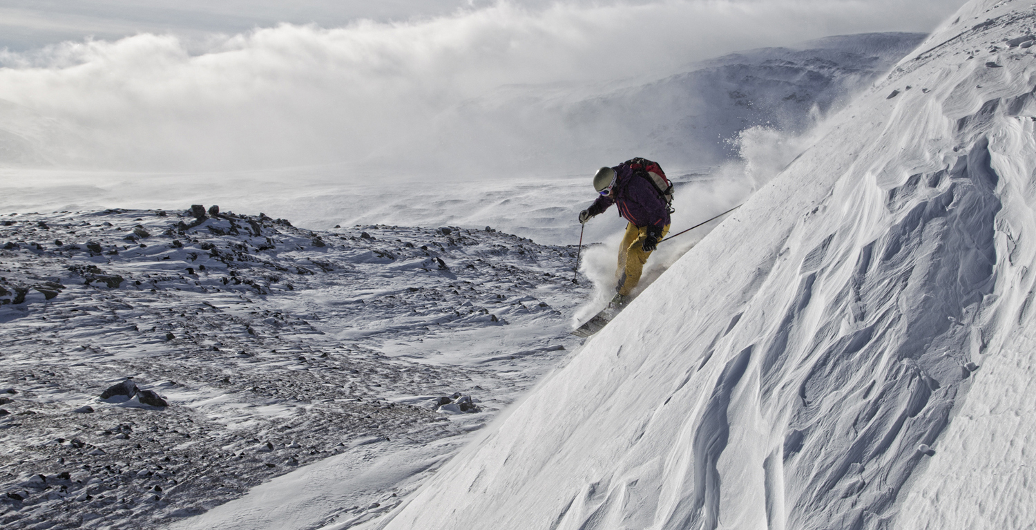 Hallingskarvet in Norway - a person is skiing down a snowy slope.