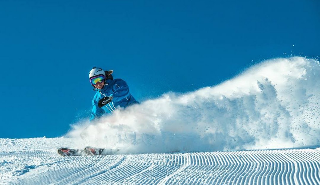 A skier gliding on the snow-covered slopes of Hallingskarvet, in Hallingdal Nonstølvegen, Hovet, Buskerud, Norway. A stunning winter sports scene at a ski resort.
