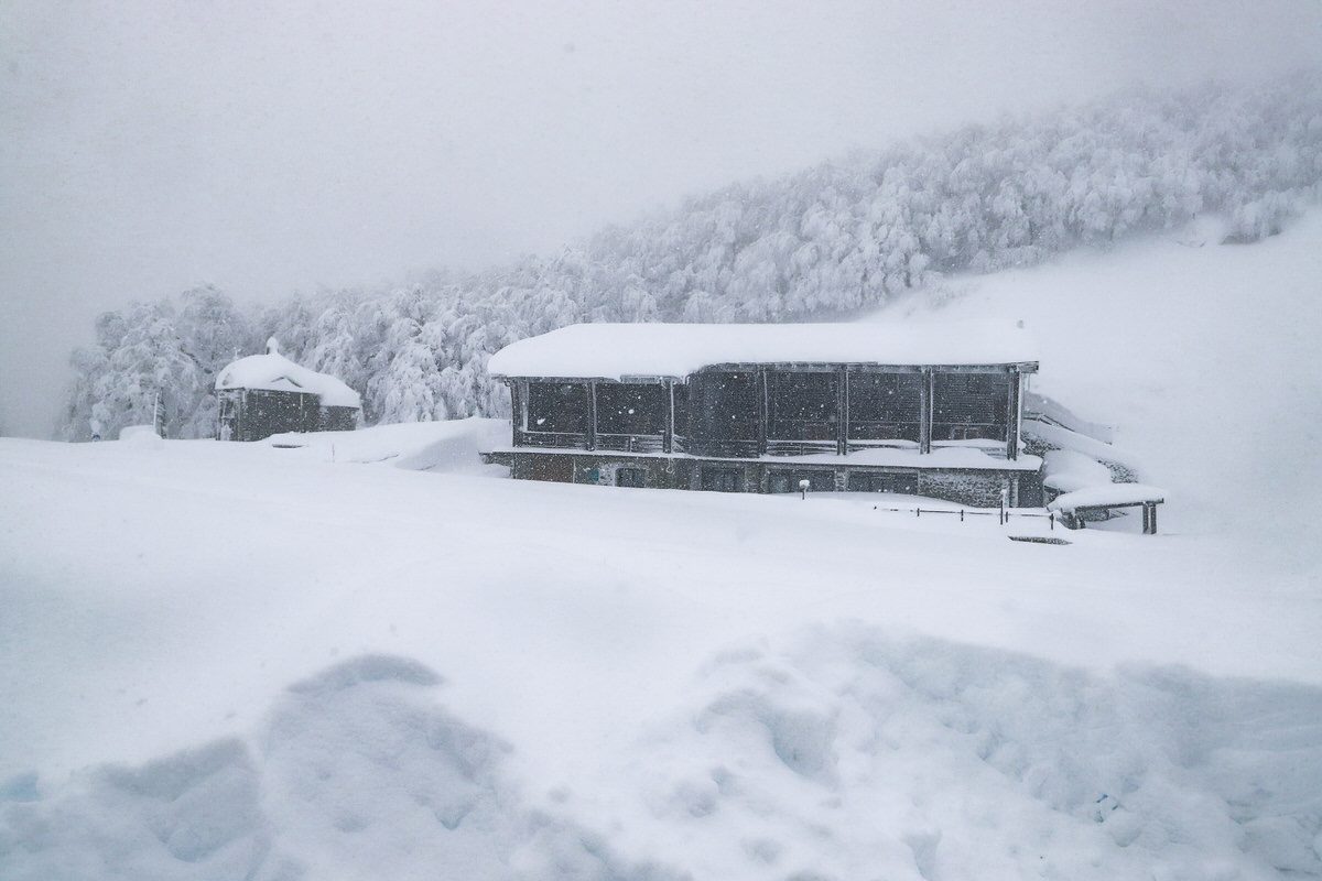 View of Passo dei Due Santi in Zum Zeri; the photo features a bustling winter sports centre amidst a ski resort, carpeted in snow. The remarkable winter scenery also has a hint of a chalet.