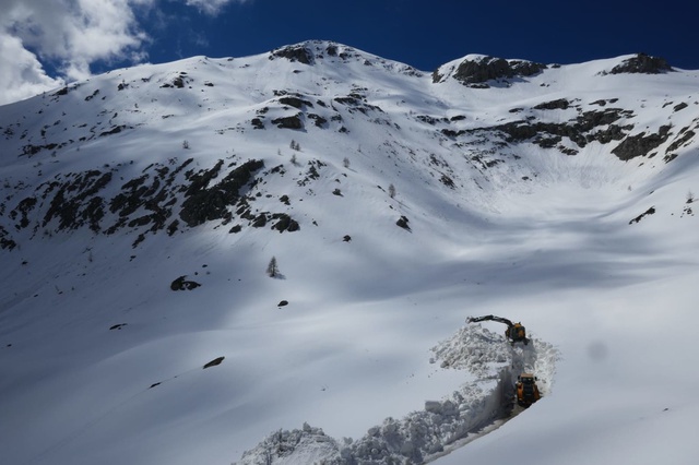 A skier enjoying a winter sports scene in Pontechianale Piedmont Italy. The backdrop features a charming chalet nestled against the stunning snowy mountains of Province of Cuneo.