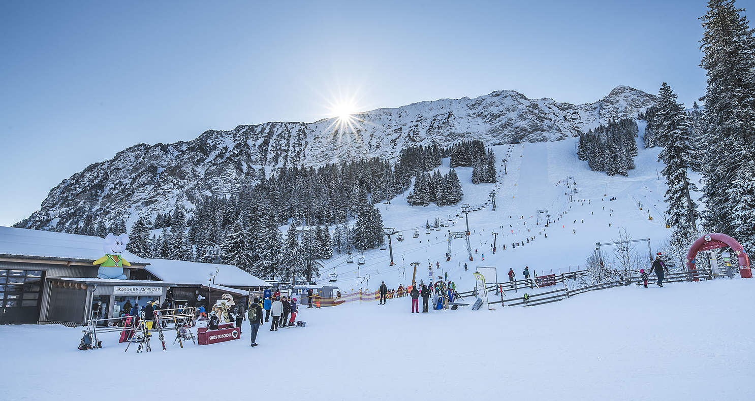 Mörlialp in Switzerland - a group of people standing in the snow.