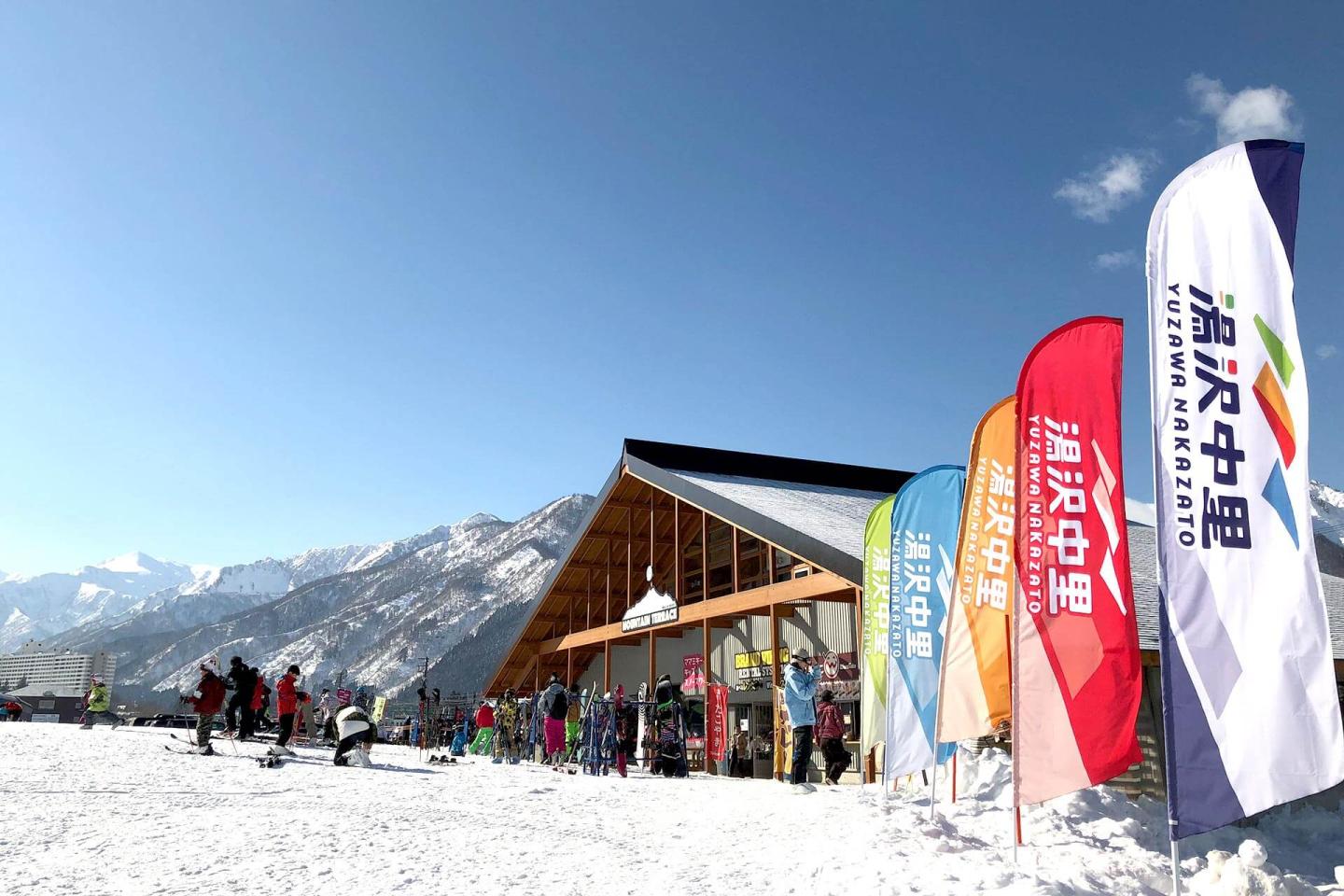 Yuzawa Nakazato in Japan - a group of people walking down a snow covered slope.