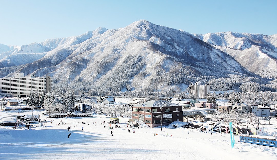 Winter view of Yuzawa Nakazato in Japan, showing stunning snow-laden scenery with a bustling ski resort vividly illustrating a lively winter sports scene.
