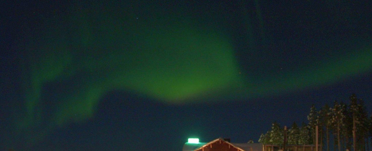 Scenic view of a chalet in Kåbdalis, Northern Sweden, nested in a beautiful winter landscape. Snow-covered mountains and a ski resort contribute to the chilly and captivating atmosphere.