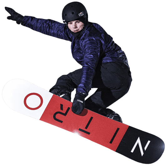 A snowboarder mid-action at The Snow Centre in Hemel Hempstead England elegantly carving through crisp white snow under bright lights. The energy and thrill of winter sports is palpable.