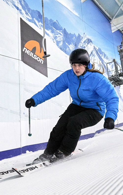 A skier and a snowboarder enjoying winter sports at The Snow Centre in Hemel Hempstead, East of England, UK. The facility provides an ideal ski resort experience.