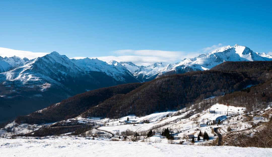 View of a charming chalet amidst Hautacam's snowy landscape in Hautes-Pyrénées, France, showcasing the picturesque winter scenery often visited for winter sports.