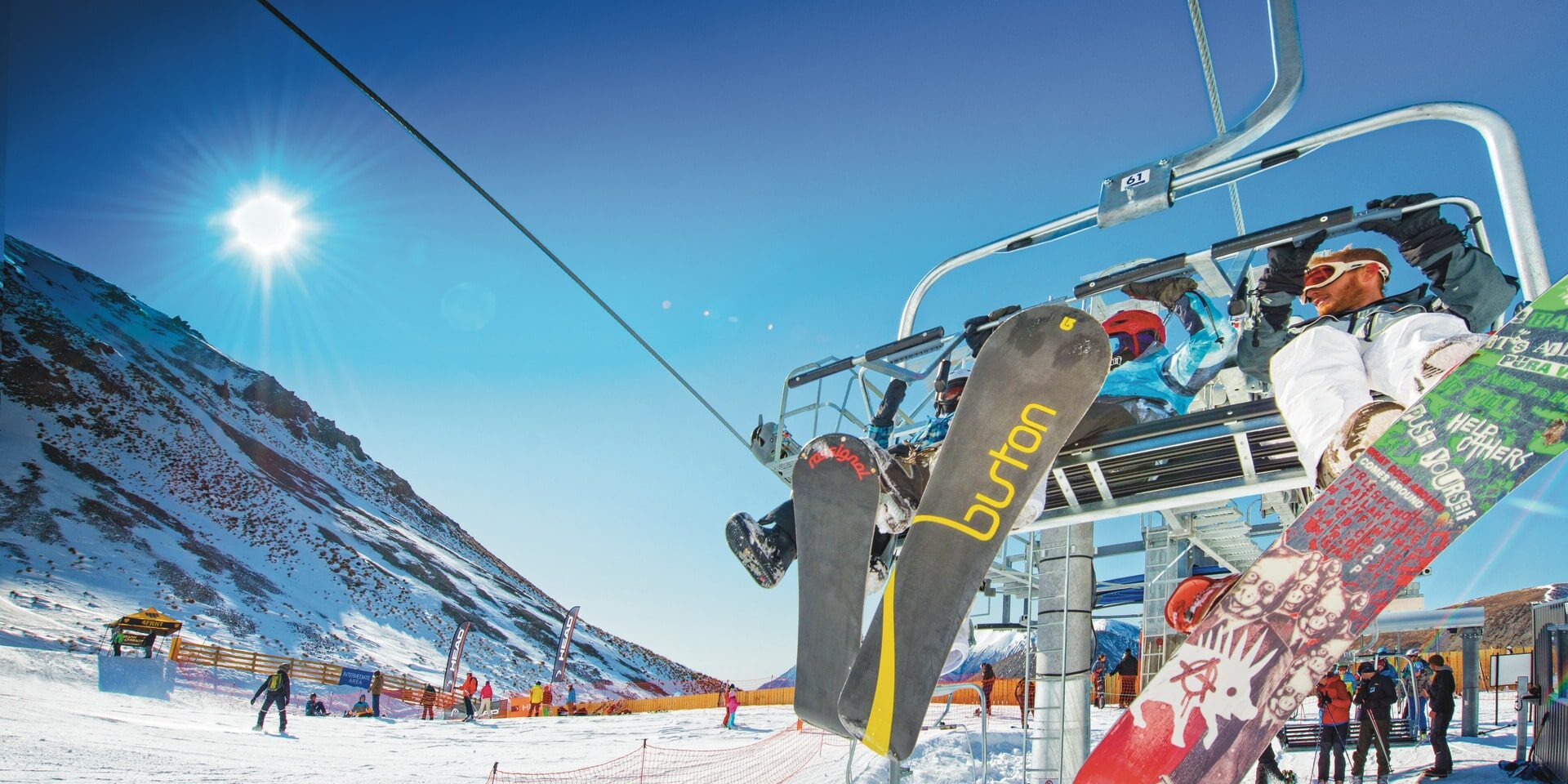Porters in New Zealand - a ski lift going up the side of a mountain.