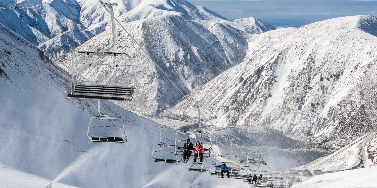 Porters in New Zealand - a ski lift going up a snowy mountain.