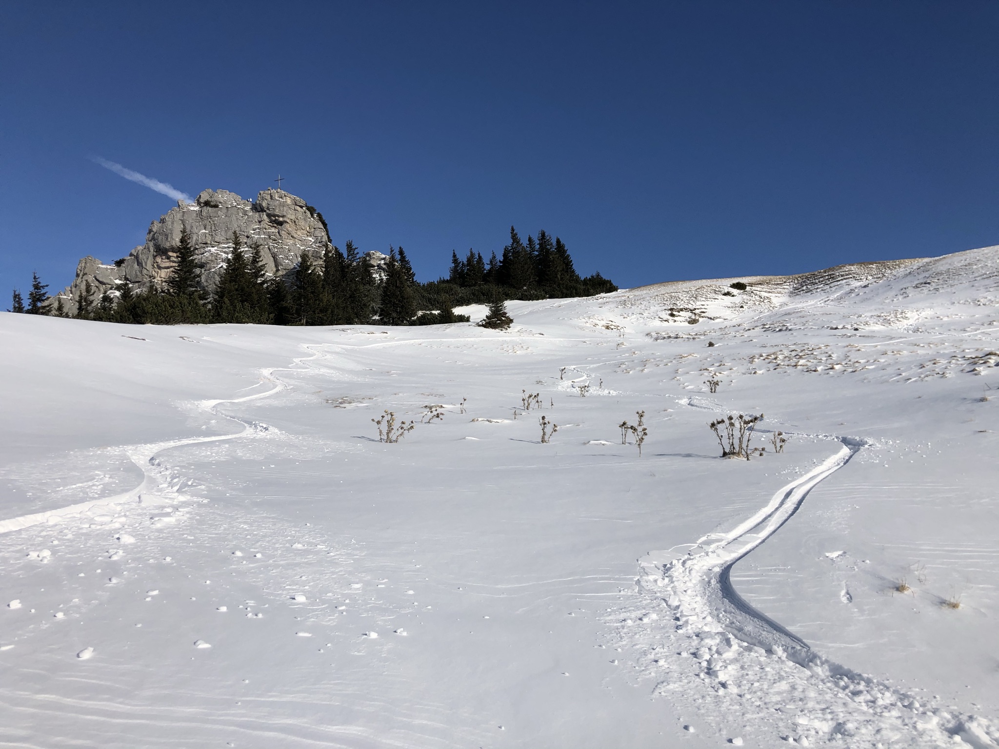 Winter sports scene in Upper Bavaria, Germany showing breathtaking winter scenery, including a chalet set against the backdrop of a snowy mountain in Tegernsee-Schliersee, Brannenburg.
